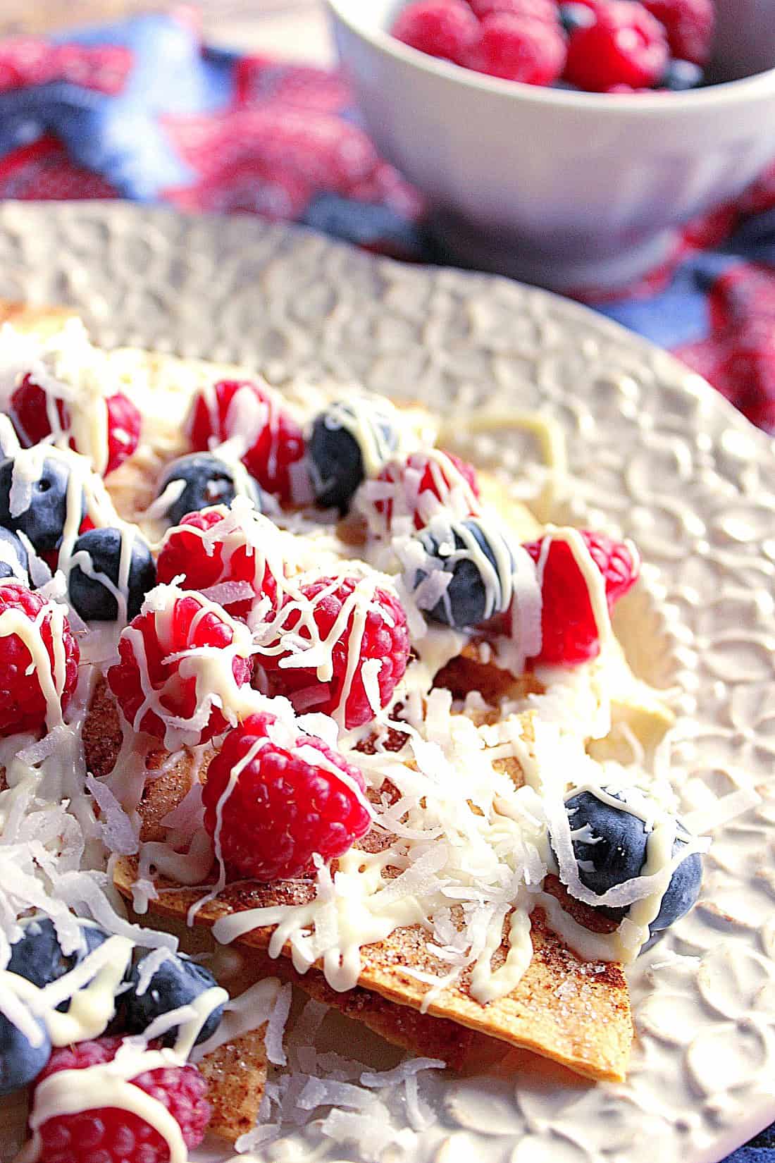 Cinnamon sugar nachos topped with berries, coconut and white chocolate.