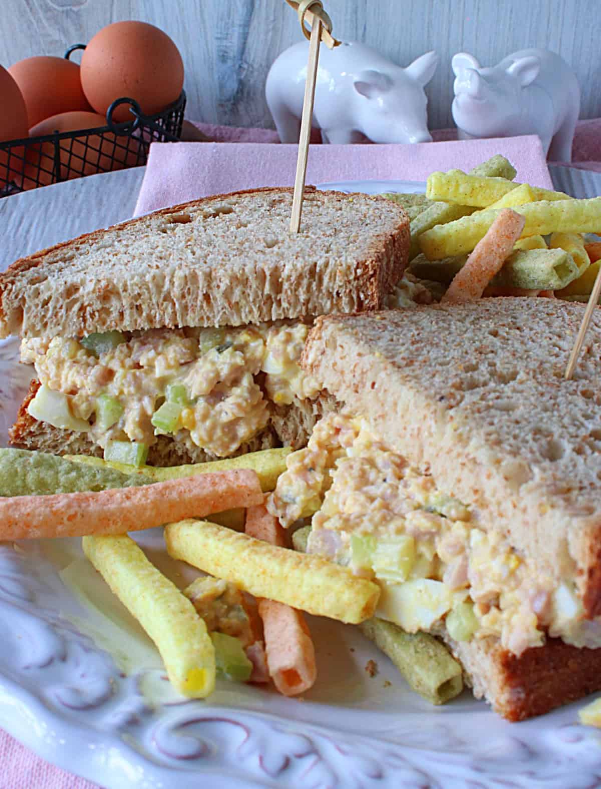 A ham and egg salad sandwich on a two slices of bread.