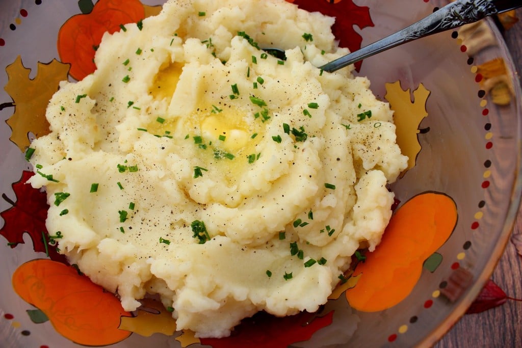 The ultimate comfort food is kicked up a notch or two with these Celery Root Mashed Potatoes. You're going to love them!! - Kudos Kitchen by Renee Celery Root Mashed Potatoes Recipe / www.kudoskitchenbyrenee.com