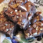Three chocolate Take 5 Candy Bar Brownies on a plate.