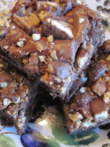 Three chocolate Take 5 Candy Bar Brownies on a plate.