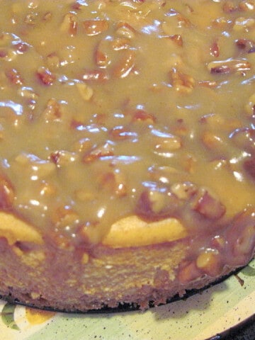 An overhead photo of a Maple Pumpkin Cheesecake with a pecan glaze.