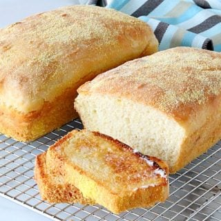 Two Loaves of English muffin bread on a wire cooling rack.