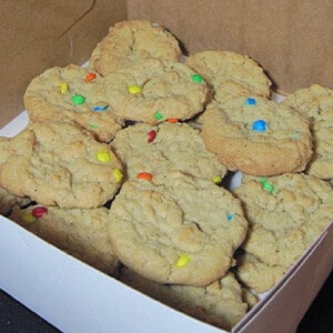 A white bakery box filled with M & M Oatmeal Cookies.