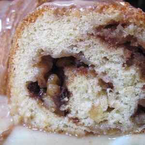 A slice of a Cinnamon Roll Cake with apples and walnuts.