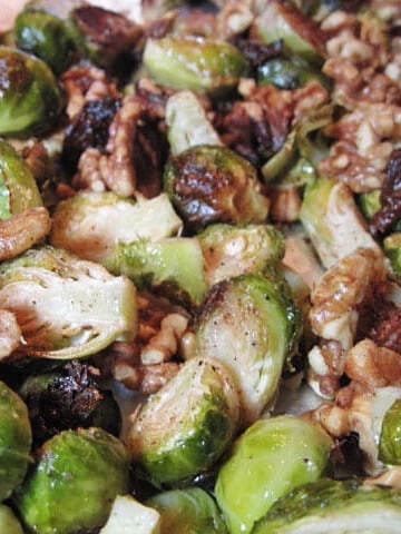A closeup photo of Roasted Brussels Sprout with walnuts on a baking sheet.