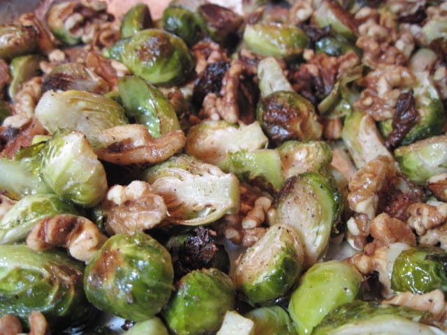 A closeup photo of Roasted Brussels Sprout with walnuts on a baking sheet.