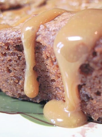 A closeup of caramel dripping off an Apple Raisin Cookie Bar.