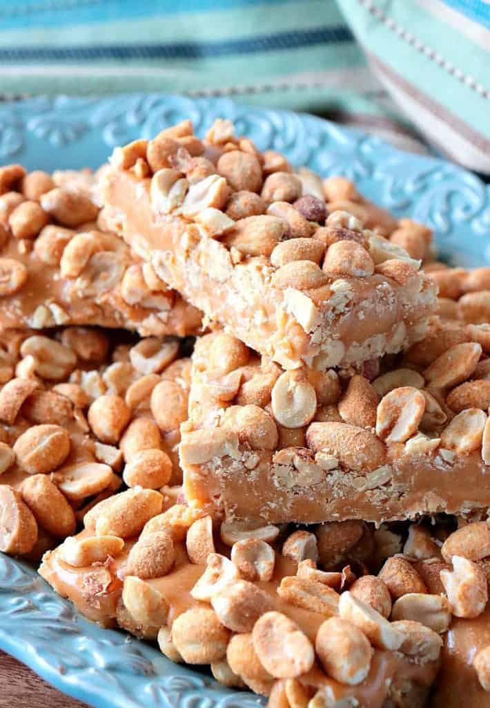 Stack of homemade copycat payday candy bars on a blue plate. 