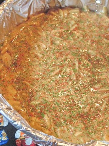 A round pan of Almond Butter Crunch Candy with aluminum foil.