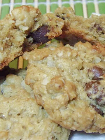 A closeup of a few Tropical Oatmeal Cookies with a green background.