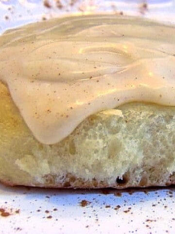 A closeup of a Cinnamon Rolls using Mashed Potatoes along with some cinnamon cream cheese icing.