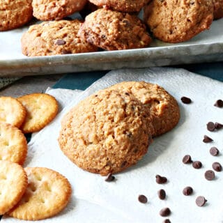 A couple of Butterscotch Ritz Cookies on a white napkin along with some Ritz cracker and some chocolate chips.