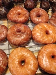 Homemade  Glazed Apple Cider Donuts on a wire rack.
