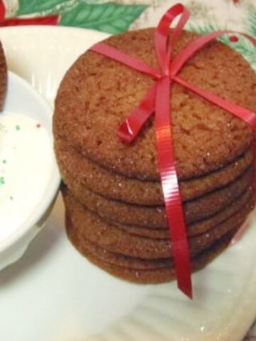 A stack of gingersnap cookies with a red bow.