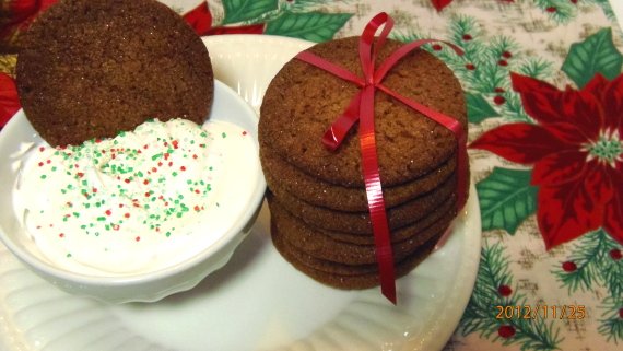A stack of Homemade Gingersnap Cookies tied with a red ribbon.