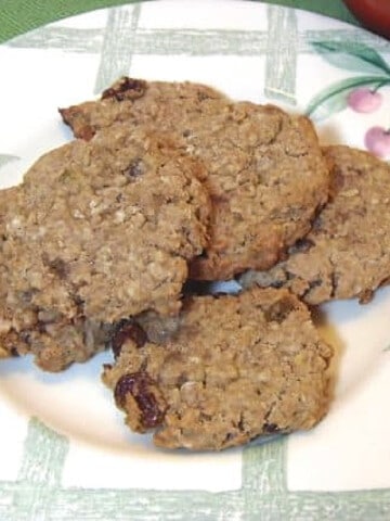 A green and white plaid plate filled with Whole Wheat Oatmeal Raisin Cookies.