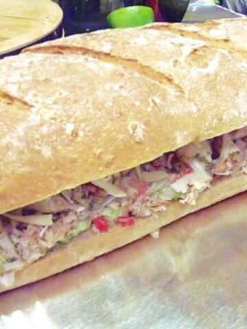 A Crab and Avocado Sandwich on a large loaf of sourdough bread.