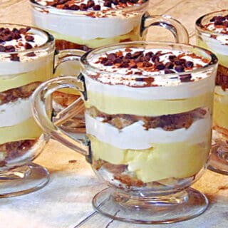 Four Skinny Tiramisu Parfaits in Irish coffee mugs with chocolate chips and whipped cream.