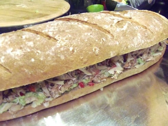 A Crab and Avocado Sandwich on a large loaf of sourdough bread.