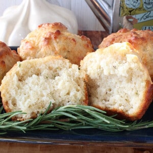 The inside of a Garlic Rosemary Focaccia Muffin on a plate with rosemary.
