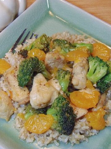 A serving of Citrus Ginger Chicken on a square, light green plate with a fork.