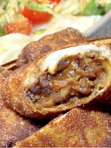 A closeup of the inside of a Cowboy Eggroll with ground beef and beans.