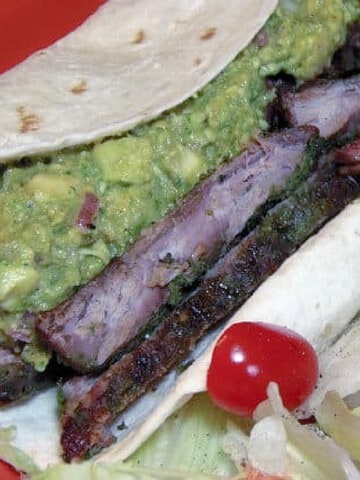 Grilled Skirt Steak with Cilantro Pesto in a flour tortilla along with guacamole.