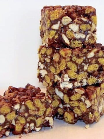 A stack of three Cap'n Crunch Cereal Bars and one more bar on the side.