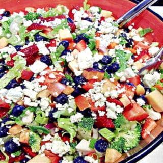 A colorful Summertime Chopped Salad with blueberries, romaine, strawberries, and blue cheese.