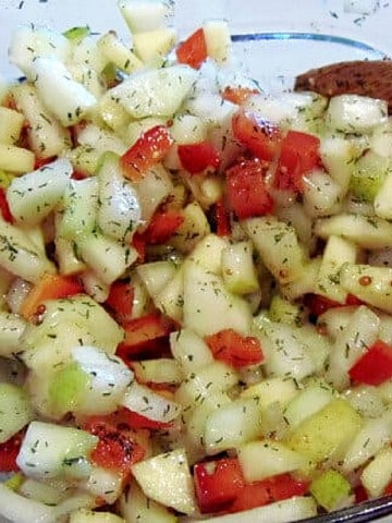 A closeup photos of a diced Apple Pear and Cucumber Salad with dill.