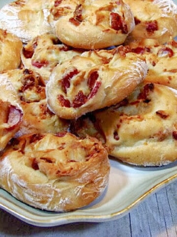 A green scalloped platter filled with delicious Roasted Radish Rolls.