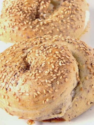A closeup of two Beirut Tahini Swirls with sesame seeds on top.