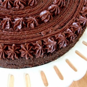 A super closeup of part of a Chocolate Velvet Cake with a pretty chocolate buttercream frosting.