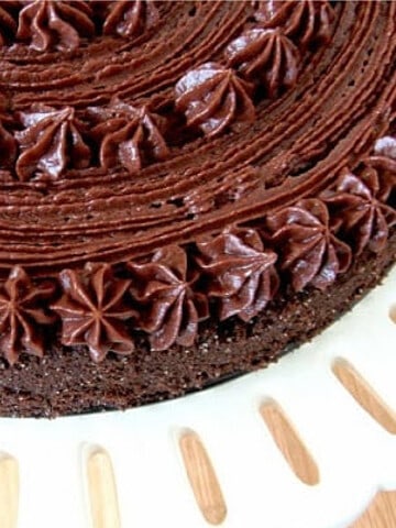 A super closeup of part of a Chocolate Velvet Cake with a pretty chocolate buttercream frosting.