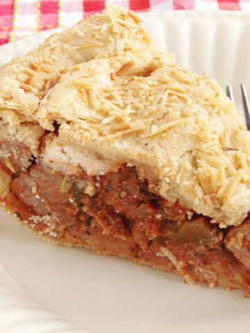 A slice of Pizza Pie on a white plate with a fork.