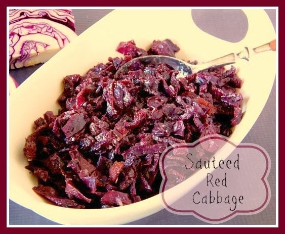 Red cabbage in a oval white bowl with a spoon.