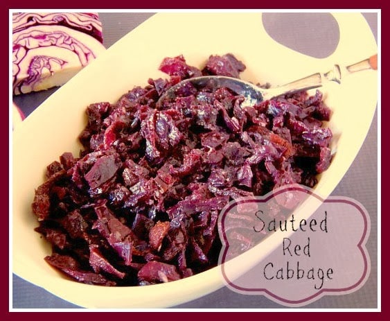 Red cabbage in a oval white bowl with a spoon.