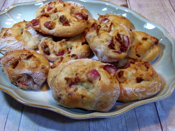 A bunch of Roasted Radish Rolls on a green scalloped platter.