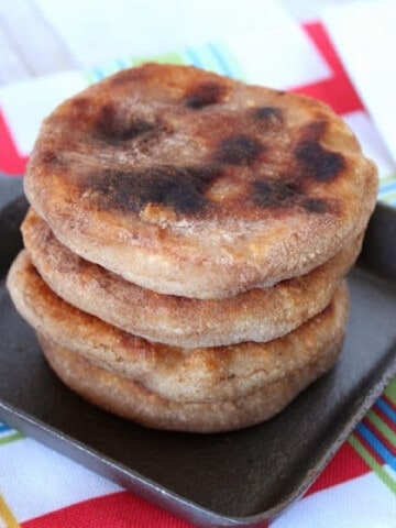 A stack of aloo paratha in a small square griddle pan.