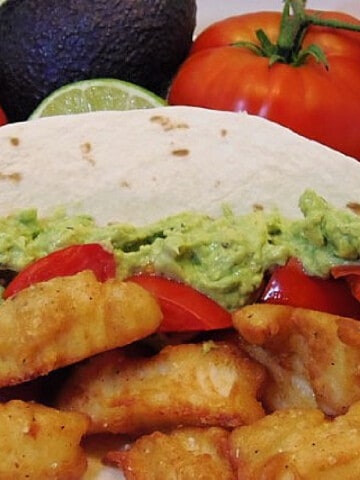 A colorful photo of Beer Batter Fish Tacos on a flour tortilla.