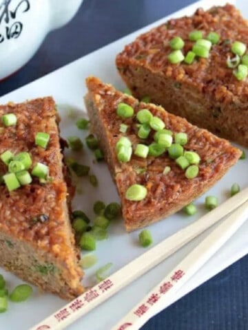Three slices of Fried Rice Frittata with scallions on top.