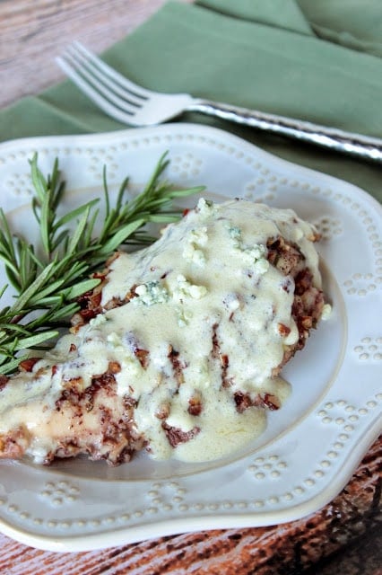 Pecan Chicken with Blue Cheese Sauce with a green napkin and a fork.
