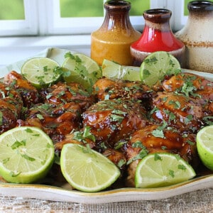 A platter filled with Teriyaki Glazed Chicken Thighs and cilantro.