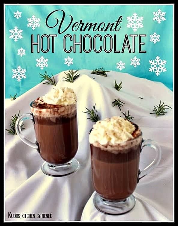 Two cups of Vermont hot chocolate on a snow covered mountain.