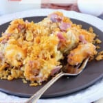 A serving of Ham and Cheese Strata on a brown plate with a fork.