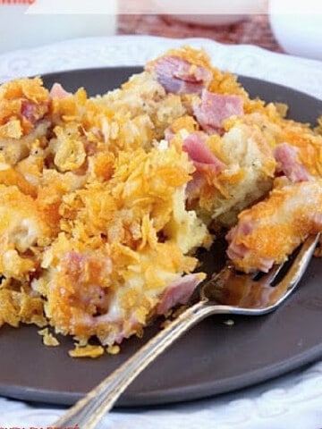 A serving of Ham and Cheese Strata on a brown plate with a fork.