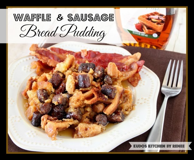 A large serving of Waffle and Sausage Bread Pudding on a white plate with a fork and some syrup.
