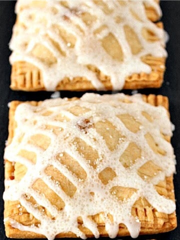 Two square Apple Hand Pies with a drizzled glaze and sanding sugar.