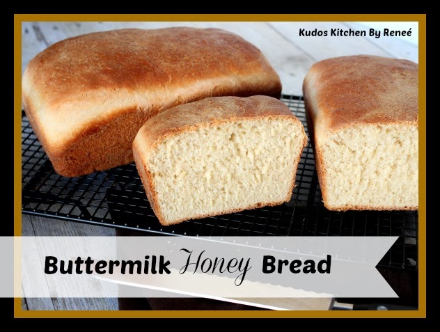 Two golden loaves of bread on a cooking rack.